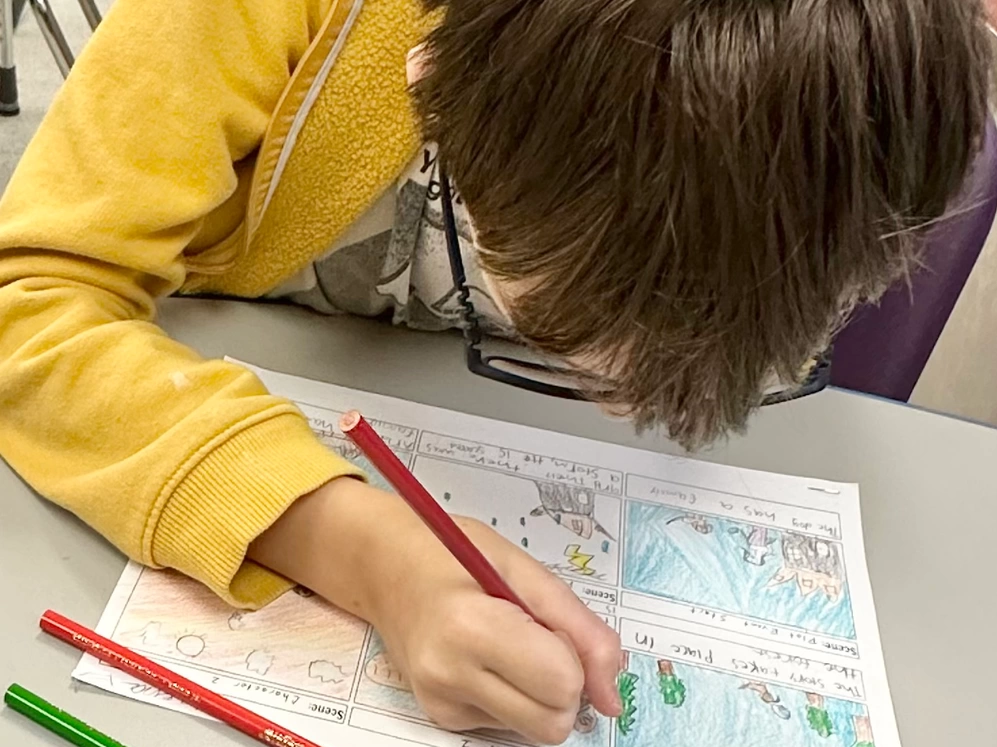 Courtesy Photo | A 4th-grade student at the Department of Defense Education Activity (DoDEA) at Irwin Intermediate School is fully engrossed in their story during the storyboarding sessions. By integrating storyboarding into the classroom, students are encouraged to develop crucial skills such as planning, collaboration, and communication. This hands-on approach makes lessons more captivating and meaningful and fosters deeper levels of comprehension and engagement among the students.